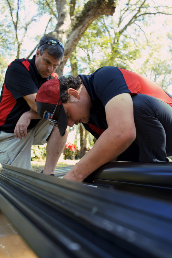 two expert RV technicians working on awning repair